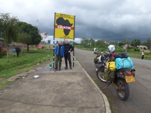 Crossing the equator; halfway round the globe. One of Africa's most popular photoshots, of course. Heavy grey skies and the dominance of Mt Kenya over the town beckoned rain to come.