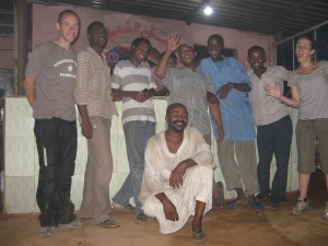 Celebrating paying the bill at the fish restaurant in Omdurman; friendly staff on hand.