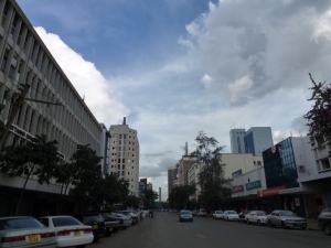 Nairobi City; once the safari capital of the world, not simply an African city anywhere in Africa. Modern highrise looking rough around the edges close up, and this thing about divisions between rich minorities and poor masses. 